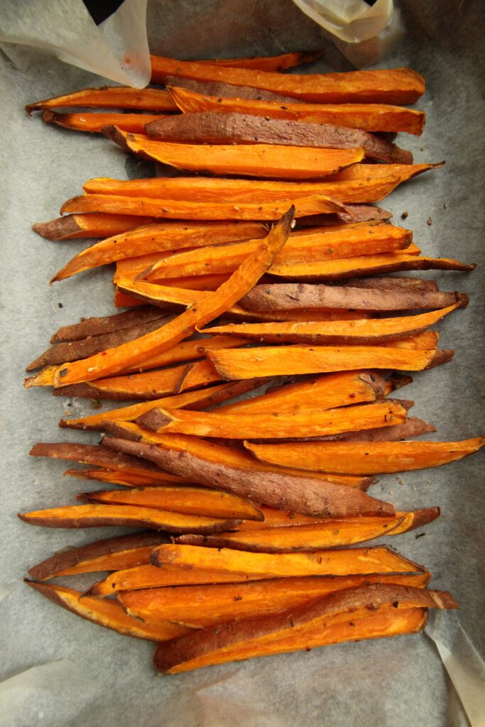 Crispy Air Fryer Sweet Potato Fries cut on platter vertical