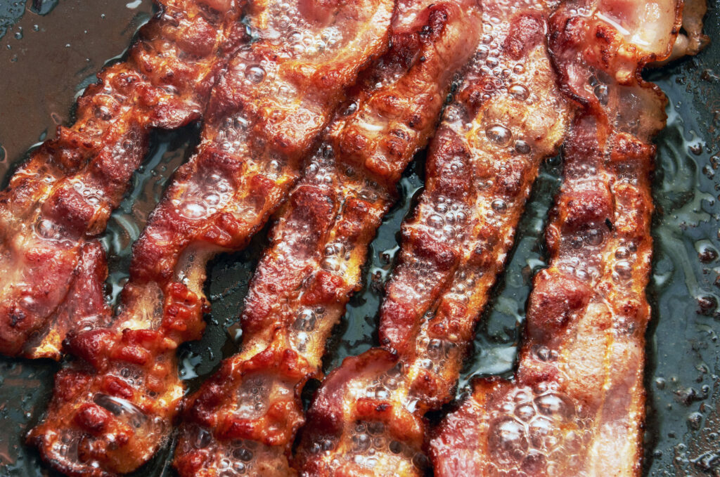 bacon frying in a pan overhead