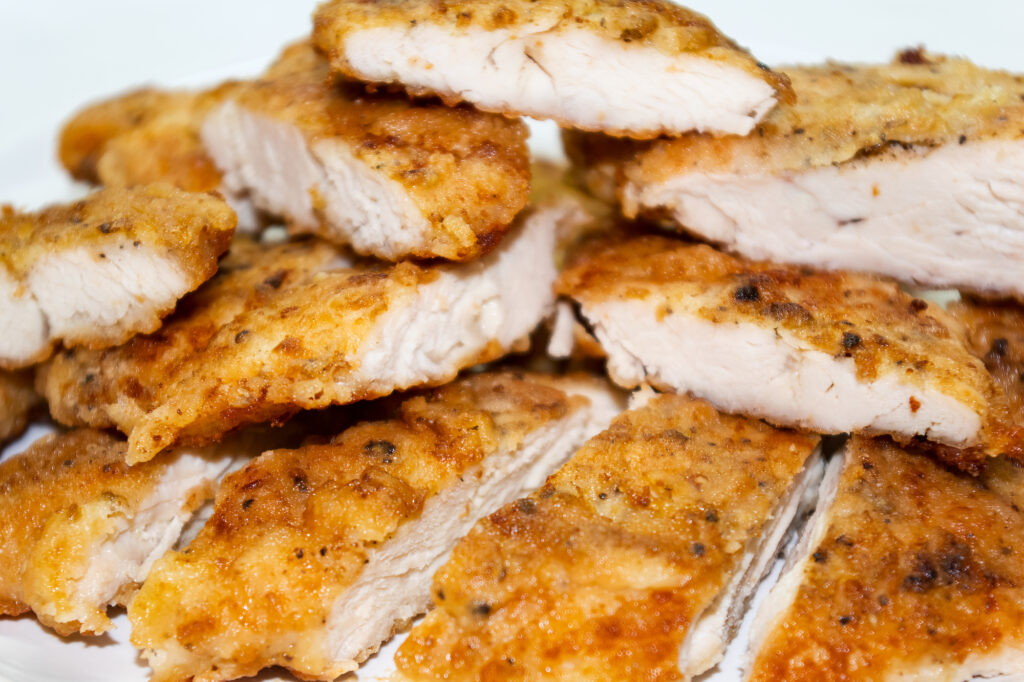 air fryer chicken cutlets cut up in stack